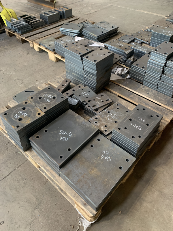 Stack of CNC plasma cut plates with etching and labeling